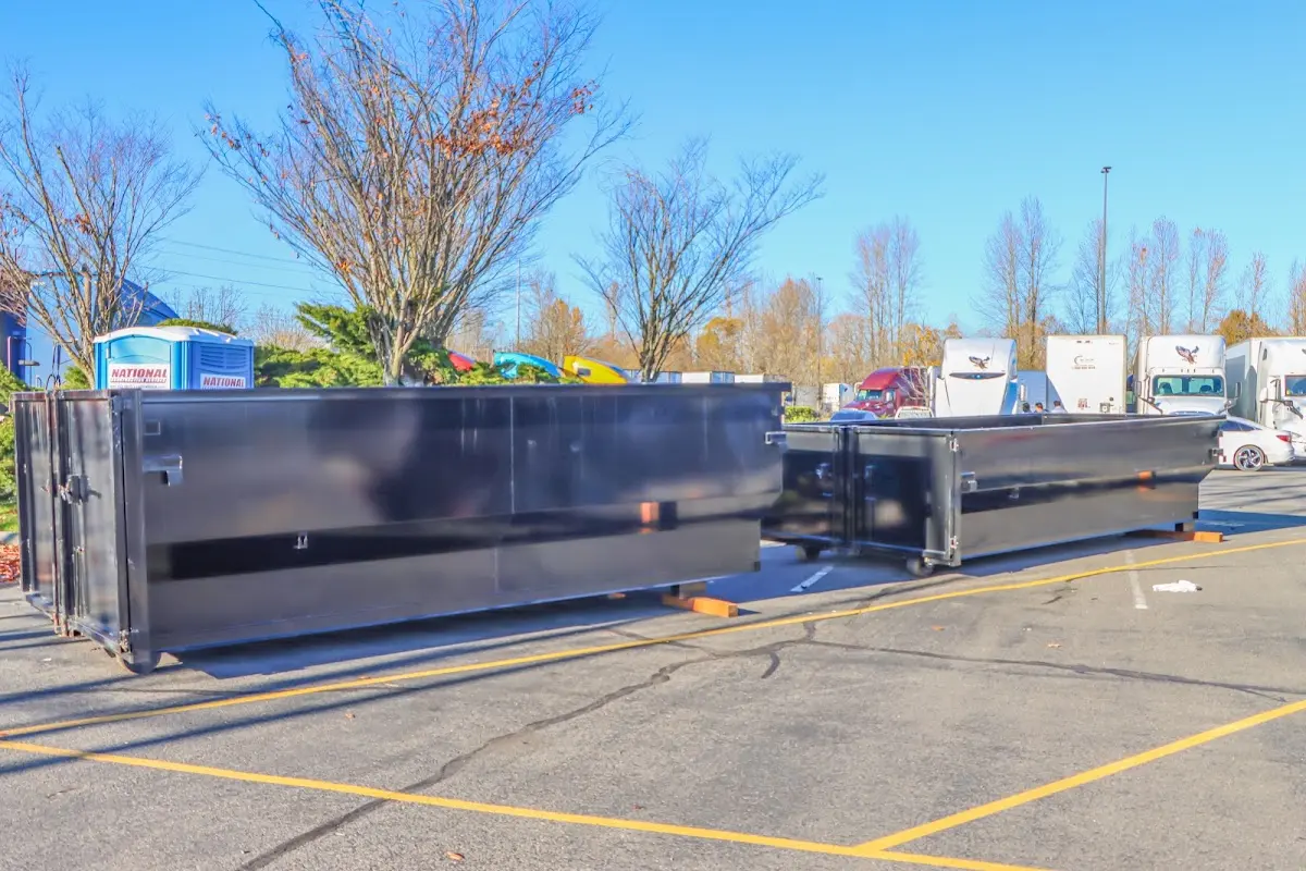 Professional dumpster rental service with roll-off container on residential driveway in Ramapo